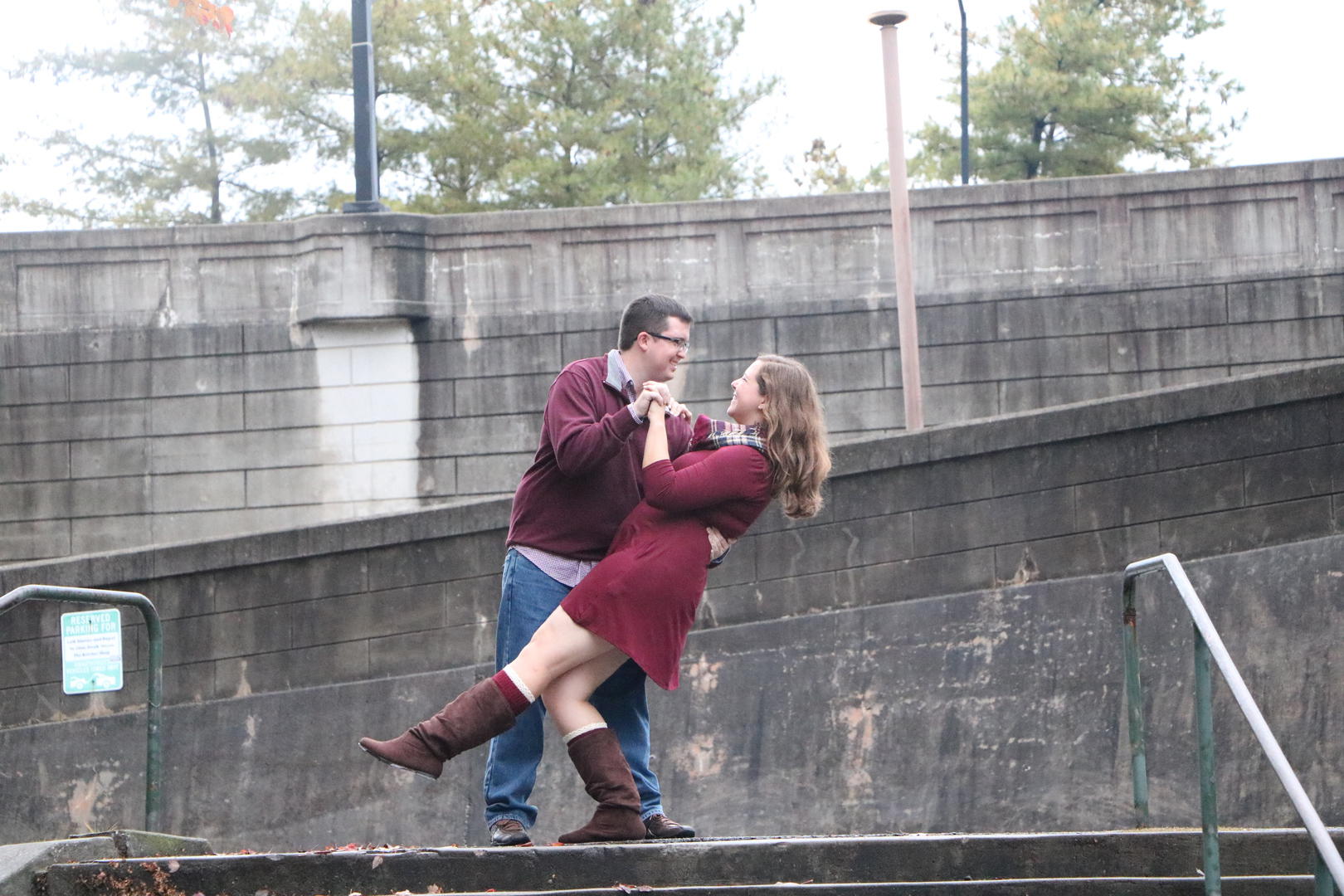 Haleigh and Sean outside dancing at the top of a set of stairs
