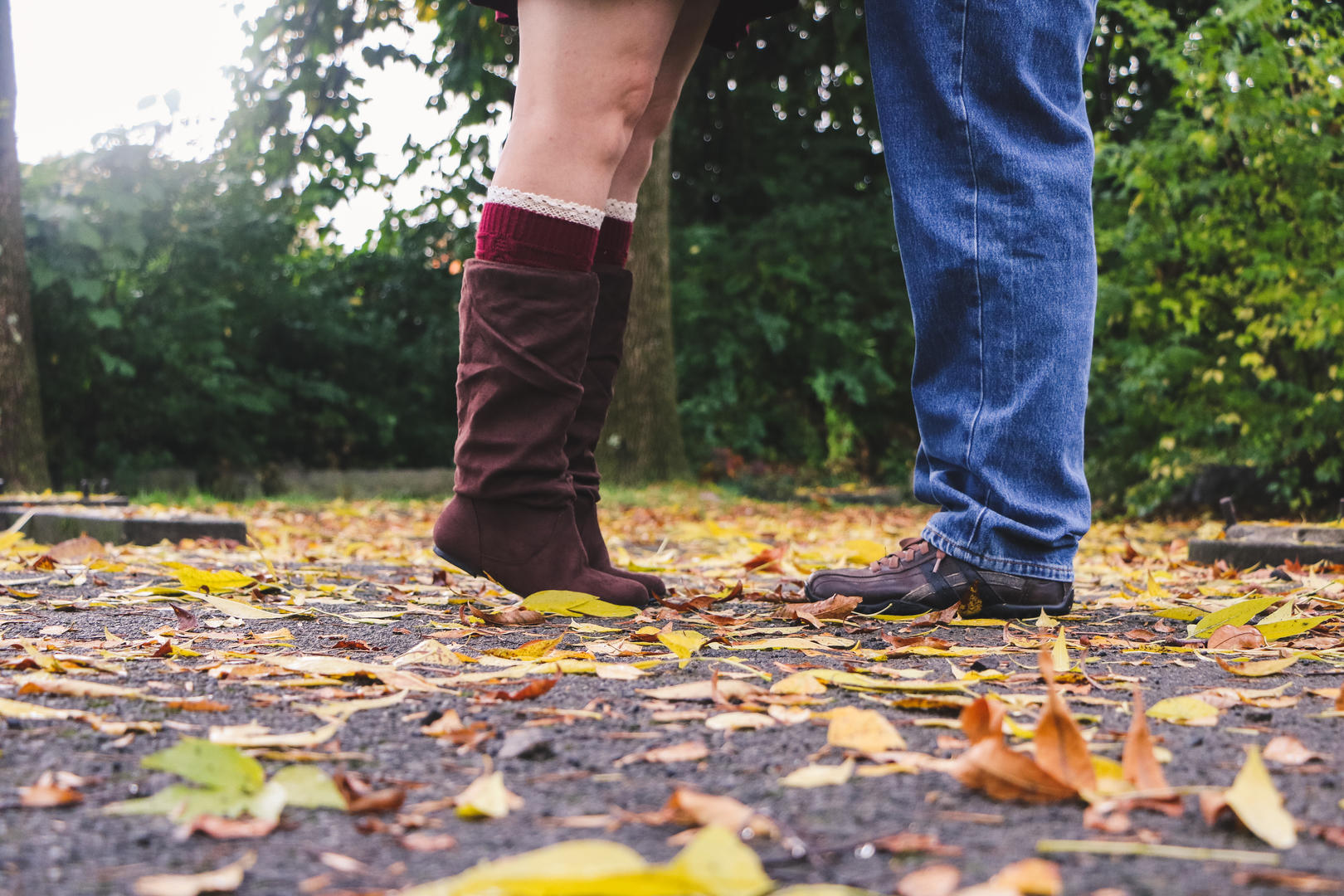 Picture of Haleigh and Sean's feet outside surrounded by fallen leaves
