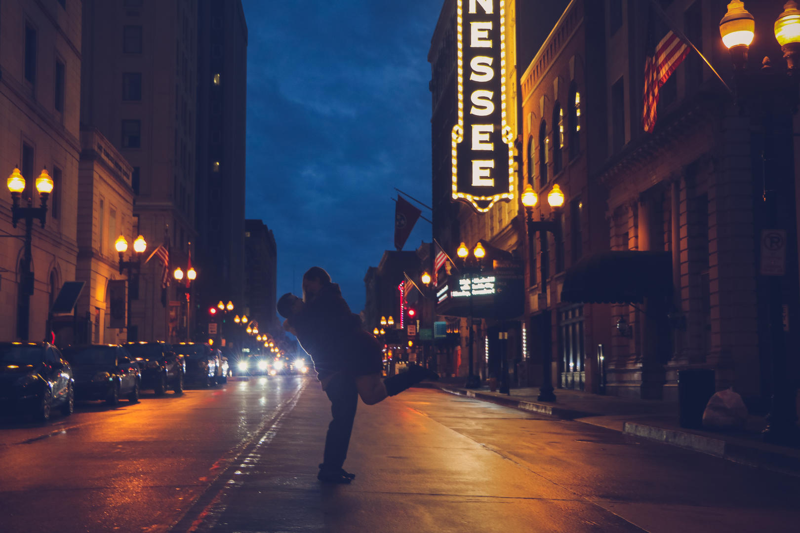 Sean picking up and holding Haleigh in the middle of the road on Gay Street in downtown Knoxville, Tennessee
