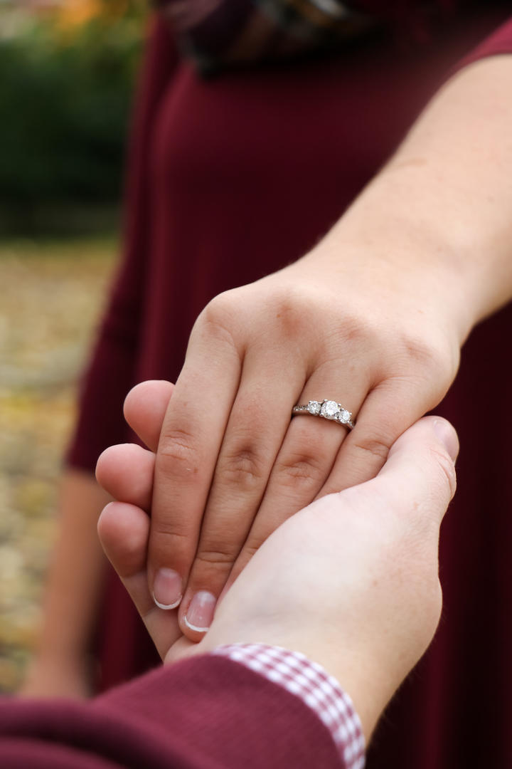 Close-up of Haleigh's engagement ring while holding hands with Sean
