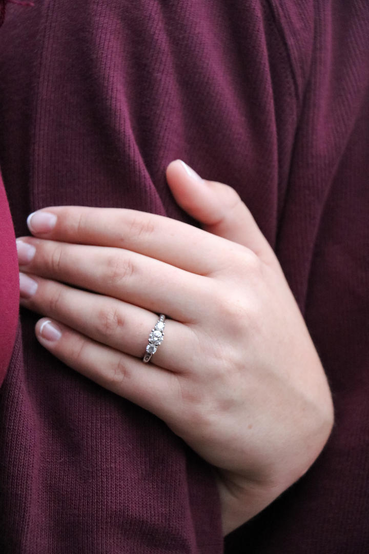 Close-up of Haleigh's engagement ring while she holds Sean's arm
